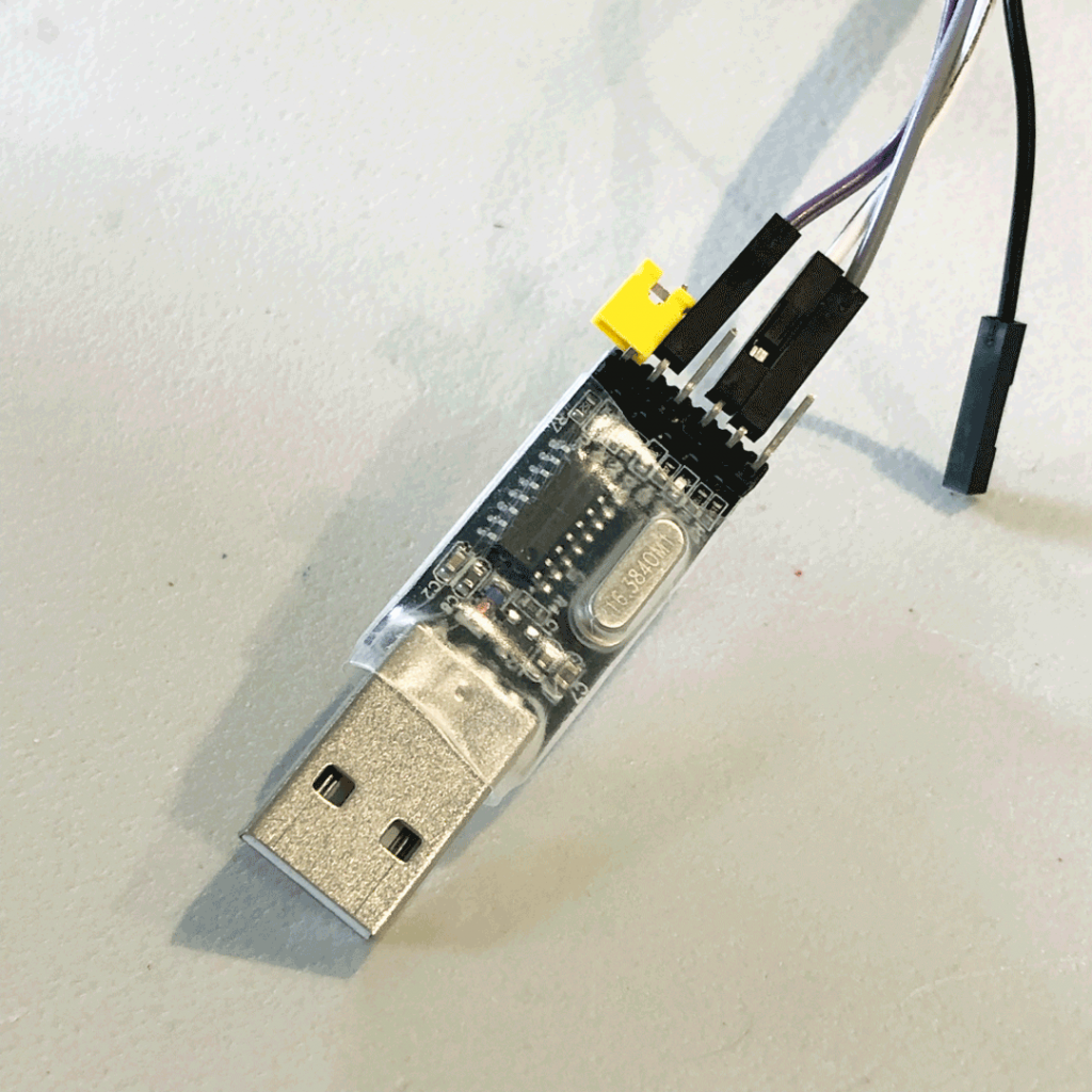 Three DuPont-style jump wires (purple, white, and gray) connected to a CH340 USB serial adapter.
