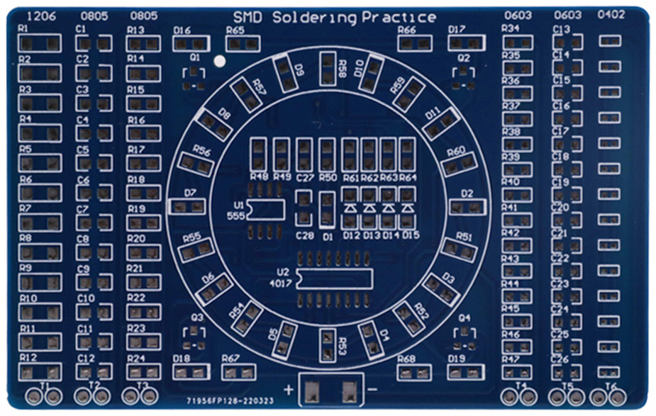 A photo of a blue printed circuit board with numbered terminals where resistors, capacitors, etc. will be soldered on. The top of the board says "SMD Soldering Practice."