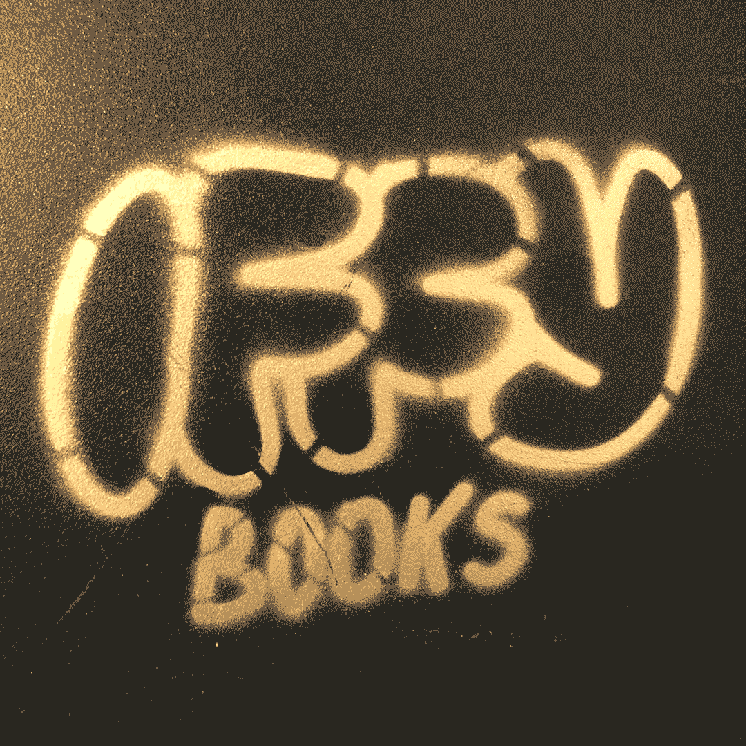 The Iffy Books logo stenciled in gold spraypaint on the side of a computer.