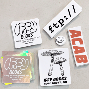 Six stickers from Iffy Books: one with a reflective background, one with white on black, one with illustrations of mushrooms, a one-inch circle, one that says "ftp://" and one that says ACAB in a style resembling a familiar logo.