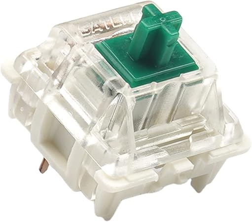 A mechanical keyboard switch with a green connector piece at the top