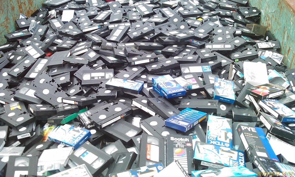 Photo of thousands of VHS tapes in a dumpster
