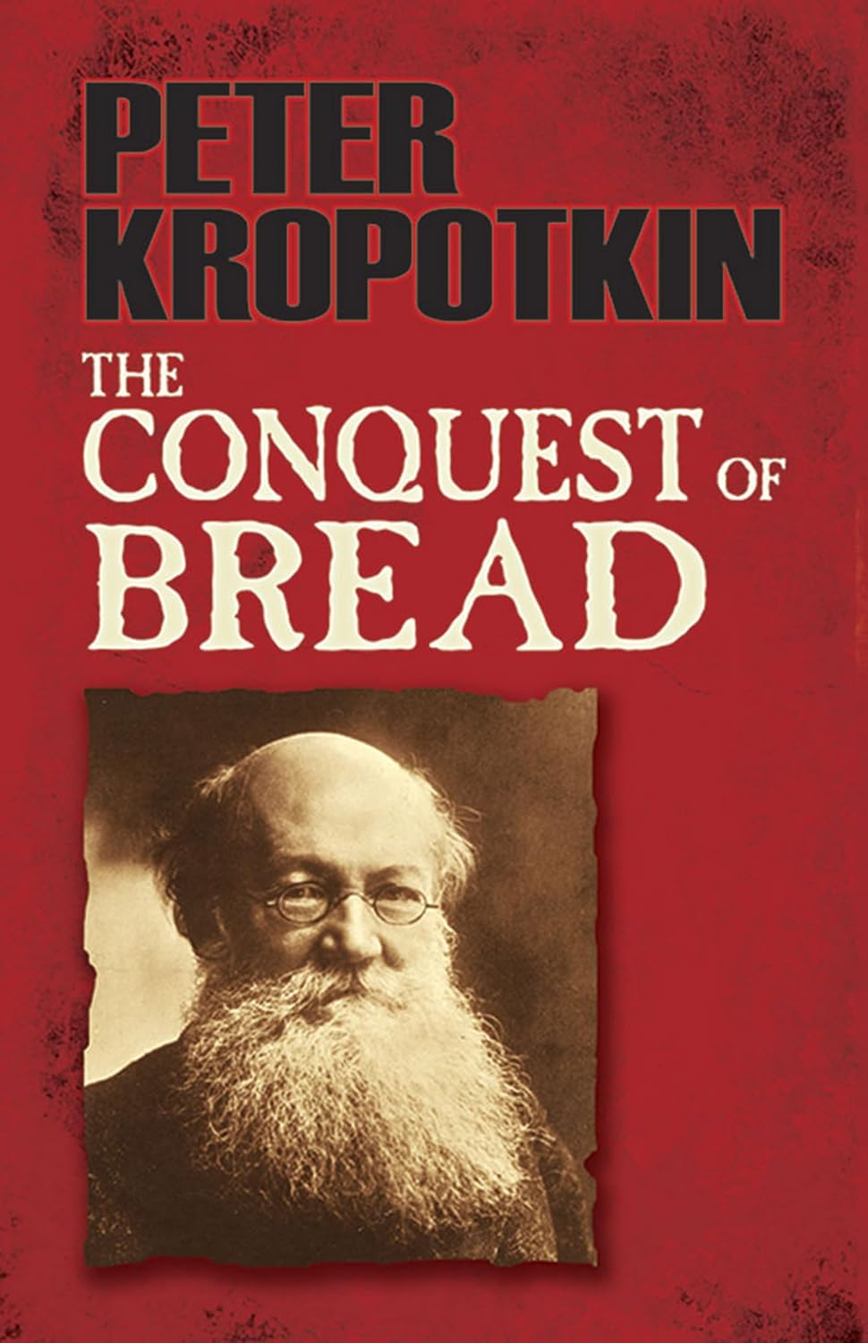 Cover of the current Dover edition of 'The Conquest of Bread' by Peter Kropotkin, with a sepia-tinted photo of the author on a dark red background